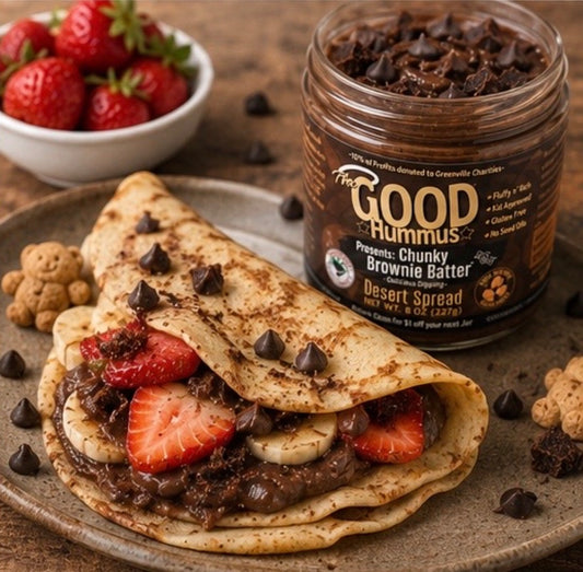 Desert spread on a wrap with strawberries and chocolate chips, next to a jar of The Good Hummus dessert spread.