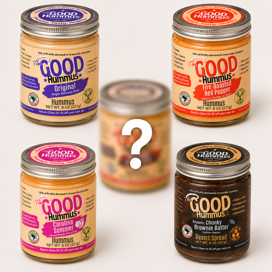 Five jars of Good Hummus with various flavors on a white background
